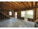 Living room area with exposed wood, large window openings, and minimal fixtures at 2355 Trelain S Dr, St Petersburg, FL 33712