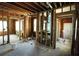 Open living room with exposed wood and electrical wiring, and a view to other rooms at 2355 Trelain S Dr, St Petersburg, FL 33712