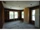 Interior featuring exposed framing, unfinished walls, windows, and a doorway, showcasing structural elements at 2355 Trelain S Dr, St Petersburg, FL 33712