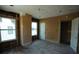 Interior view of a room with exposed framing, unfinished walls, windows, and a doorway at 2355 Trelain S Dr, St Petersburg, FL 33712