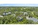Aerial view of the blue townhome roofs surrounded by trees in the community at 290 Winchester Way, Palm Harbor, FL 34684