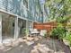 Wooden deck with sliding doors, outdoor seating, and a partially fenced yard at 290 Winchester Way, Palm Harbor, FL 34684