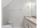 Half bathroom with vanity, marble countertop, and decorative fixtures at 290 Winchester Way, Palm Harbor, FL 34684