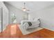 Spacious bedroom with vaulted ceiling, fan, wood floors and large windows providing ample natural light at 290 Winchester Way, Palm Harbor, FL 34684