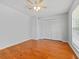 Bright bedroom features hardwood floors and a closet for storage at 290 Winchester Way, Palm Harbor, FL 34684