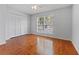 Bedroom features hardwood floors, a ceiling fan and a closet for storage at 290 Winchester Way, Palm Harbor, FL 34684