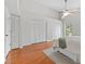 Bright bedroom featuring hardwood floors, fan and multiple closets for storage at 290 Winchester Way, Palm Harbor, FL 34684