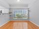 Dining area with hardwood floors and large windows for natural light at 290 Winchester Way, Palm Harbor, FL 34684
