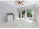 Bright dining area with tile flooring, modern ceiling fan, and sliding glass doors to the outdoor space at 290 Winchester Way, Palm Harbor, FL 34684