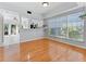 Bright dining area adjacent to kitchen, featuring hardwood floors and large window at 290 Winchester Way, Palm Harbor, FL 34684