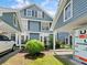 Charming home exterior with blue siding, carport, and well-maintained landscaping at 290 Winchester Way, Palm Harbor, FL 34684