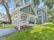 Street view of blue townhouse featuring a U-Box moving container in the carport at 290 Winchester Way, Palm Harbor, FL 34684
