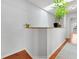 Hallway with hardwood floors, skylight, a modern plant adding natural light to the space at 290 Winchester Way, Palm Harbor, FL 34684