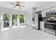 Eat-in kitchen with stainless steel appliances and sliding glass doors leading to outdoor deck at 290 Winchester Way, Palm Harbor, FL 34684