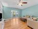 Bright living room featuring a large bay window and gleaming hardwood floors at 290 Winchester Way, Palm Harbor, FL 34684