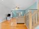 Open living room with hardwood floors, bay window, and stairway access at 290 Winchester Way, Palm Harbor, FL 34684