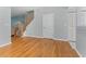 Open-concept living space with hardwood floors and staircase at 290 Winchester Way, Palm Harbor, FL 34684