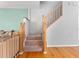 Carpeted staircase with wooden railing and safety gate at 290 Winchester Way, Palm Harbor, FL 34684