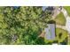 Aerial view showcasing the property, surrounding trees, and neighborhood at 31096 Inwood Cir, Brooksville, FL 34602