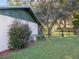 Landscaped backyard with lush greenery, patio access, and mature trees at 31096 Inwood Cir, Brooksville, FL 34602