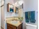 Well-maintained bathroom with a classic vanity, updated mirror, and practical towel racks at 31096 Inwood Cir, Brooksville, FL 34602