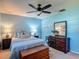 Comfortable bedroom features a ceiling fan, window, and ample furnishings at 31096 Inwood Cir, Brooksville, FL 34602