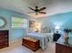 Comfortable bedroom features a ceiling fan, window, and ample furnishings at 31096 Inwood Cir, Brooksville, FL 34602