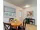 Cozy dining area with a round wood table, seating for four, and natural light from the window at 31096 Inwood Cir, Brooksville, FL 34602
