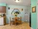 Charming dining area features a wood table with natural light from the window at 31096 Inwood Cir, Brooksville, FL 34602