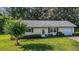 Charming one-story home with a well-maintained lawn and manicured landscaping at 31096 Inwood Cir, Brooksville, FL 34602
