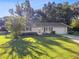 View of home with well-manicured lawn and tree providing shade at 31096 Inwood Cir, Brooksville, FL 34602
