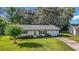 Charming home with well-manicured lawn and attached garage at 31096 Inwood Cir, Brooksville, FL 34602