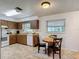 Functional kitchen and dining space with wood-look cabinets, appliances, and natural lighting at 31096 Inwood Cir, Brooksville, FL 34602