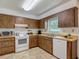 Well-lit kitchen with wood-look cabinets, modern appliances, and efficient counter space near the sink at 31096 Inwood Cir, Brooksville, FL 34602