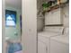 This laundry room boasts a washer, dryer, and storage shelves at 31096 Inwood Cir, Brooksville, FL 34602