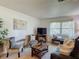 Relaxing living room featuring comfortable seating, natural light from the window, and contemporary decor at 31096 Inwood Cir, Brooksville, FL 34602