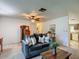 Comfortable living room with decorative furnishings, a ceiling fan, and access to other living spaces at 31096 Inwood Cir, Brooksville, FL 34602