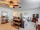 Inviting living room features a cozy seating area, decorative shelving, and modern ceiling fan at 31096 Inwood Cir, Brooksville, FL 34602