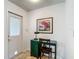 Entryway features a functional office nook with a green desk, a door, and neutral tile flooring at 31096 Inwood Cir, Brooksville, FL 34602