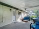 Covered and screened patio with seating area and access to the home's exterior at 31096 Inwood Cir, Brooksville, FL 34602