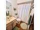 A tidy bathroom featuring a sink, toilet, shower, and wood look vinyl flooring at 35140 Whispering Oaks Blvd, Dade City, FL 33523