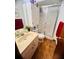 Bathroom with shower, vinyl floor, cream colored vanity, and a red towel at 35140 Whispering Oaks Blvd, Dade City, FL 33523