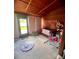 A charming bedroom with wooden walls, a crib, and colorful toys at 35140 Whispering Oaks Blvd, Dade City, FL 33523