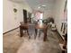 View of a simple dining room with a table and chairs adjoining the living area at 35140 Whispering Oaks Blvd, Dade City, FL 33523