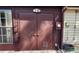 Utility access door with metal doors, an adjacent window, and an electrical panel outside the house at 35140 Whispering Oaks Blvd, Dade City, FL 33523