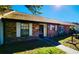 Cozy brick townhouse with white shutters and a dark-colored front door, offering a welcoming entrance at 35140 Whispering Oaks Blvd, Dade City, FL 33523