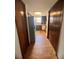 View of the kitchen from the hallway, featuring dark cabinets and appliances, including a refrigerator on the side at 35140 Whispering Oaks Blvd, Dade City, FL 33523