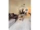 Bright living room with a gray sofa, dining table, and ceiling fan, offering a comfortable and inviting space at 35140 Whispering Oaks Blvd, Dade City, FL 33523