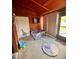 A carpeted playroom with wood paneled walls, a doorway and a playpen at 35140 Whispering Oaks Blvd, Dade City, FL 33523