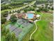 Aerial view featuring a community pool, tennis courts, sand volleyball, and other community amenities at 3718 Beneraid St, Land O Lakes, FL 34638